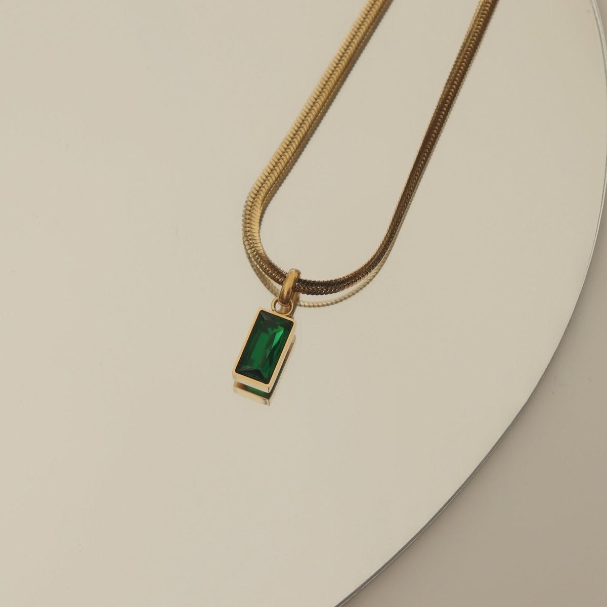 Green crystal charm with snake bone chain