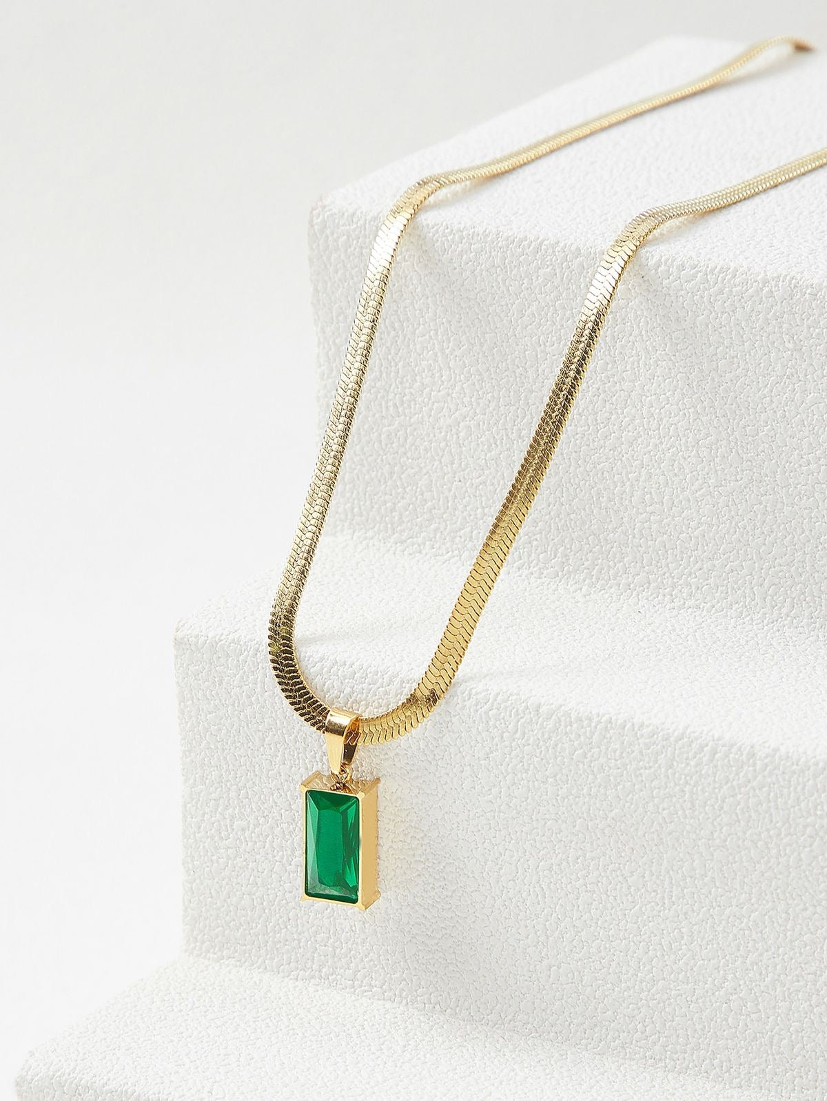Green crystal charm with snake bone chain
